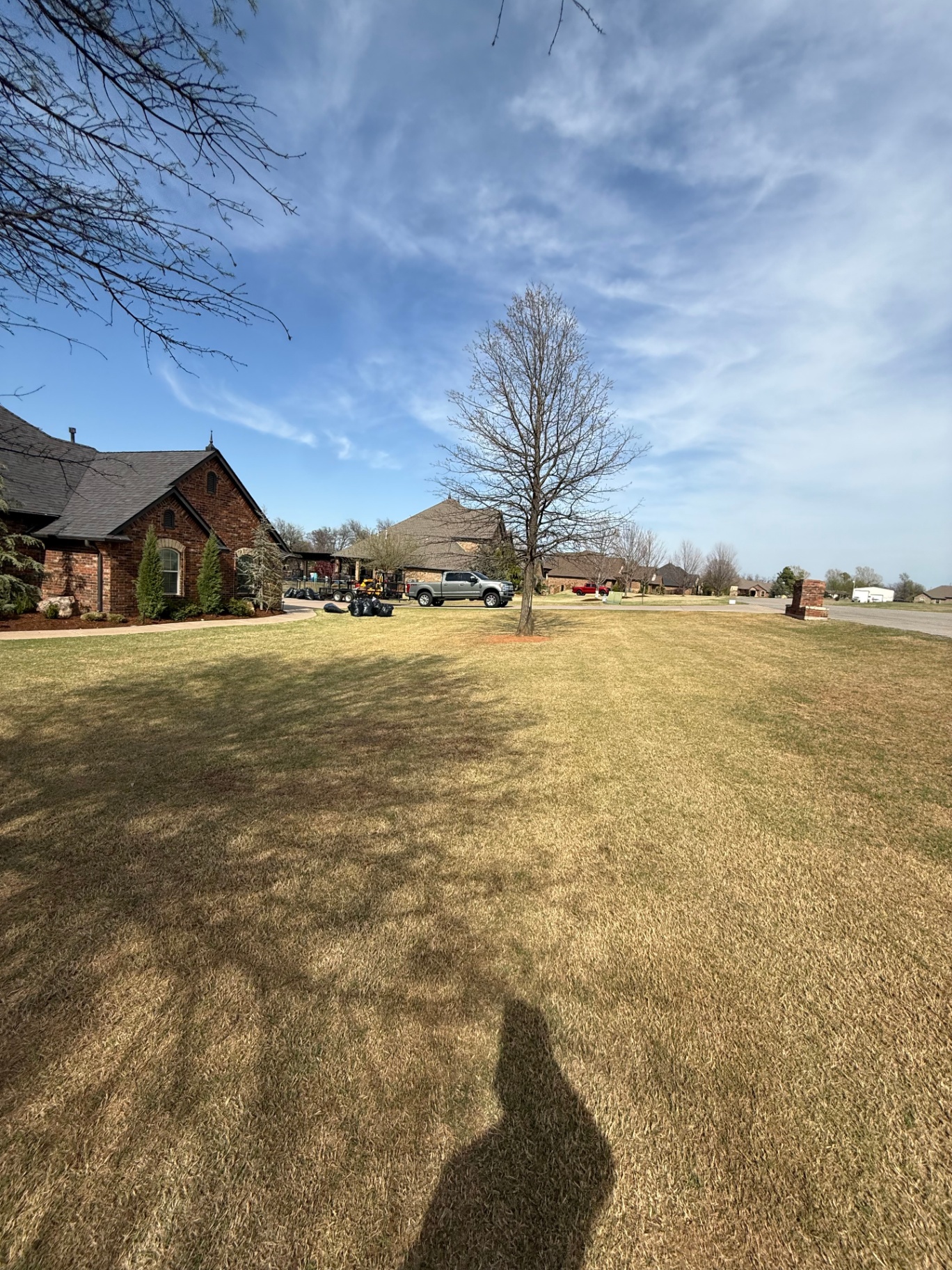 work site with truck and mulch bags on a residential street in Tuttle Oklahoma